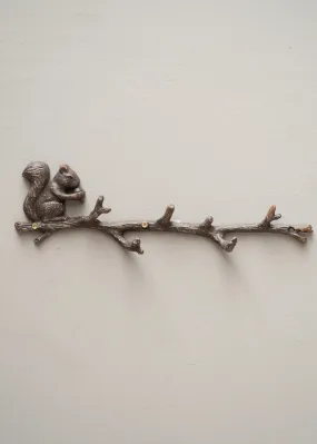 Coat rack with squirrel on branch