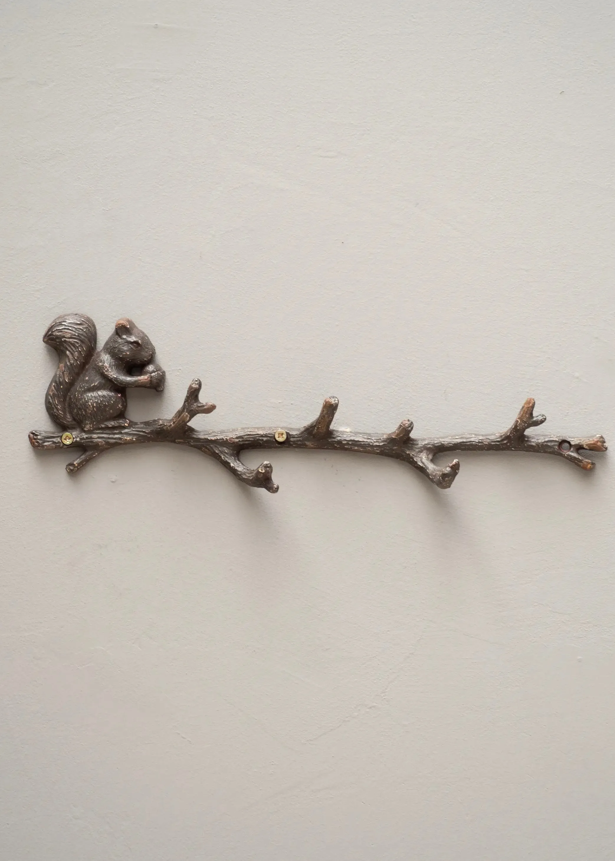 Coat rack with squirrel on branch
